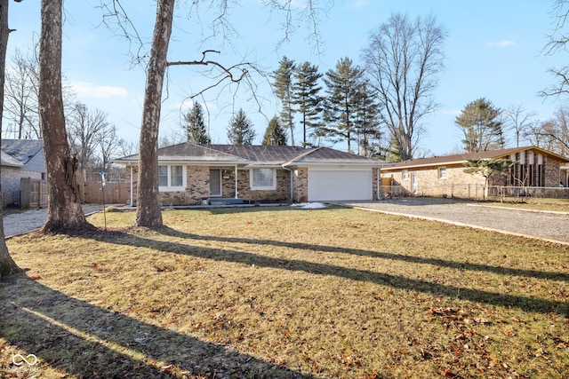 single story home featuring a garage and a front lawn