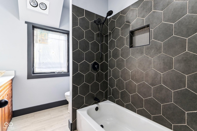 3707 N Kenwood Ave, Indianapolis, IN 46208 - full bathroom featuring vanity, tiled shower / bath, hardwood / wood-style floors, and toilet