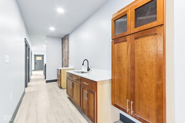 3707 N Kenwood Ave, Indianapolis, IN 46208 - interior space with a barn door, sink, and light hardwood / wood-style flooring