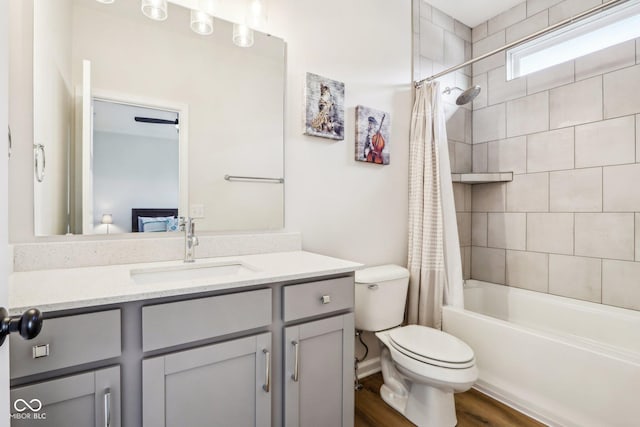 full bathroom featuring shower / tub combo with curtain, vanity, and toilet