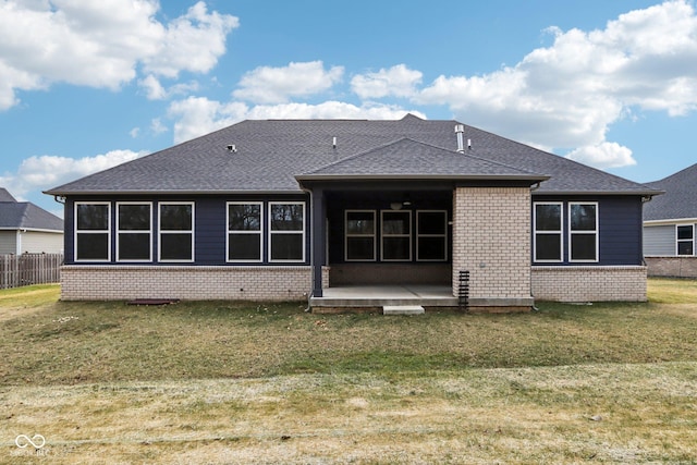 back of property with a lawn and a patio