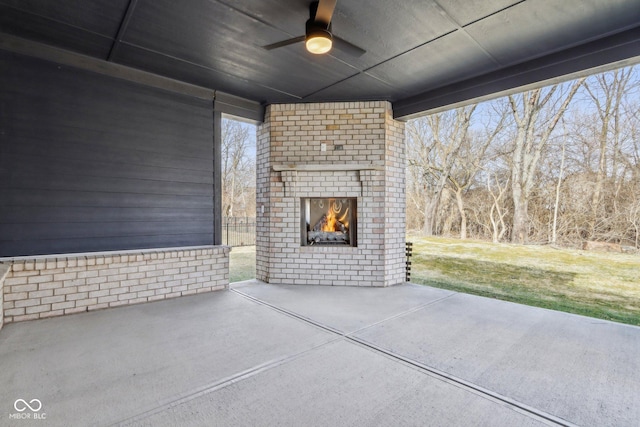 view of patio / terrace featuring an outdoor brick fireplace and ceiling fan