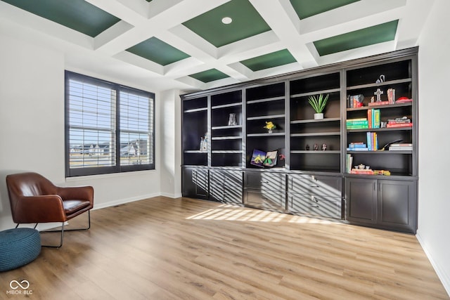 sitting room with hardwood / wood-style flooring, coffered ceiling, and beam ceiling