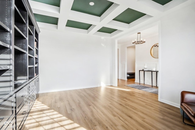 interior space featuring coffered ceiling, a notable chandelier, wood-type flooring, and beamed ceiling