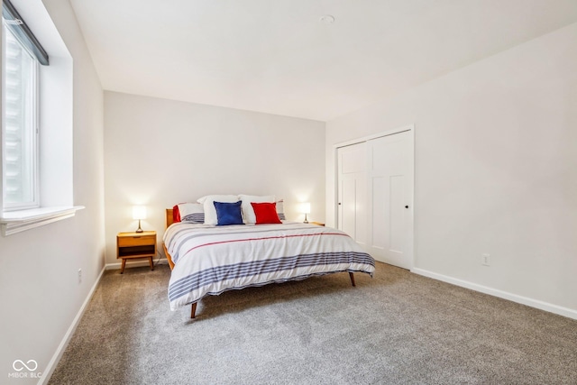 carpeted bedroom with multiple windows and a closet