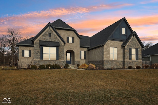 french country inspired facade with a yard