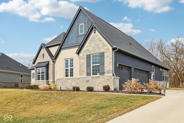 view of side of property with central AC unit, a garage, and a lawn