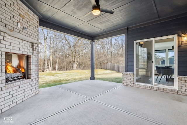 view of patio / terrace with an outdoor brick fireplace and ceiling fan