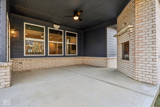 view of patio / terrace featuring an outdoor fireplace and ceiling fan