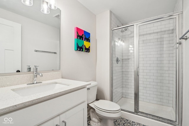 bathroom with vanity, walk in shower, and toilet