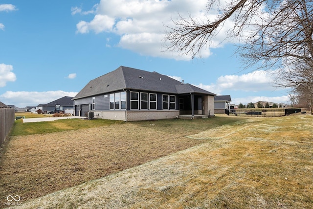 rear view of house with a yard