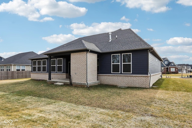 rear view of house with a lawn