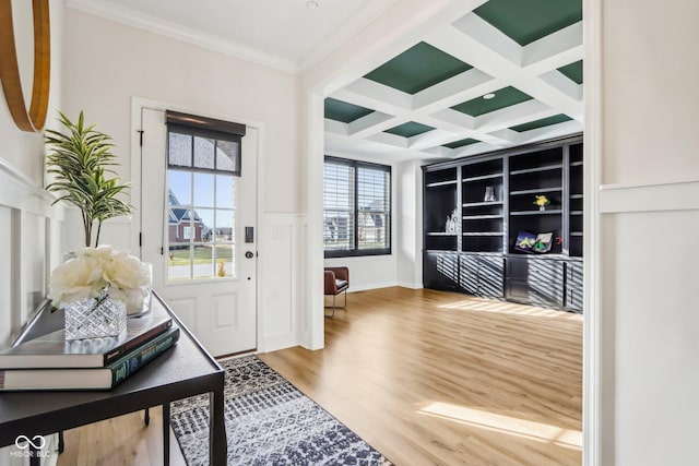 entrance foyer featuring coffered ceiling, hardwood / wood-style flooring, ornamental molding, and beamed ceiling