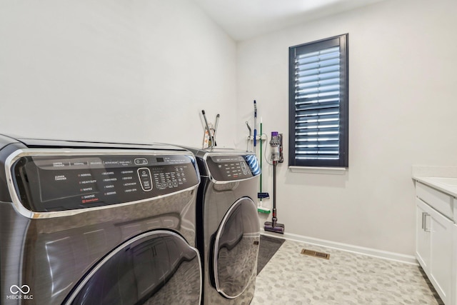 laundry area with cabinets and independent washer and dryer