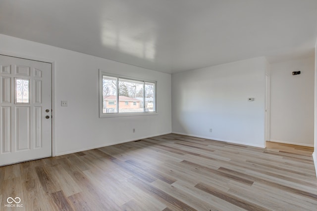 foyer featuring light wood-style floors and baseboards