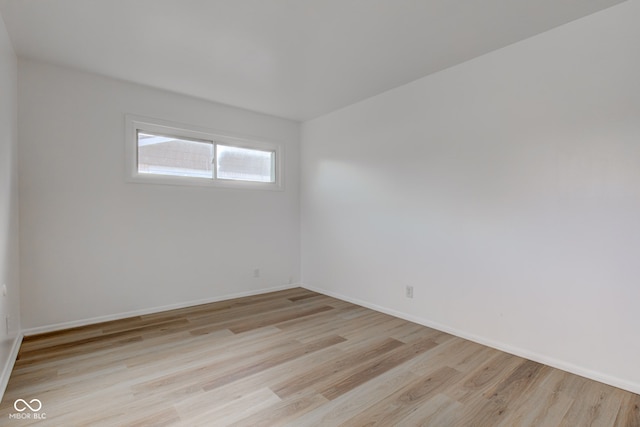 unfurnished room featuring light wood-style flooring and baseboards