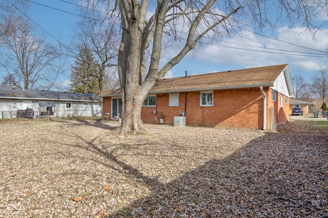 back of house featuring brick siding