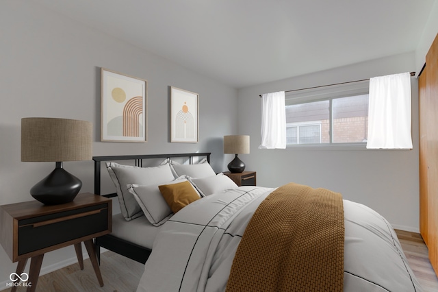 bedroom featuring light wood-type flooring and baseboards