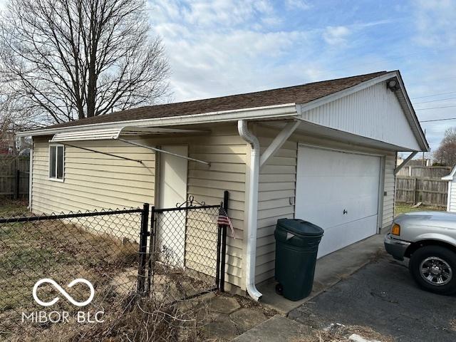 view of home's exterior with a garage and an outdoor structure