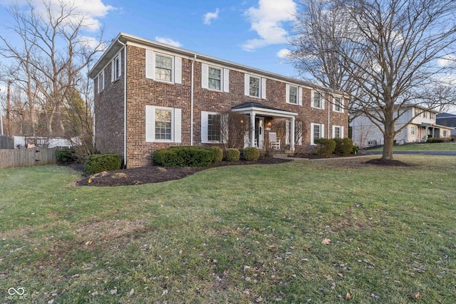 colonial inspired home featuring a front lawn