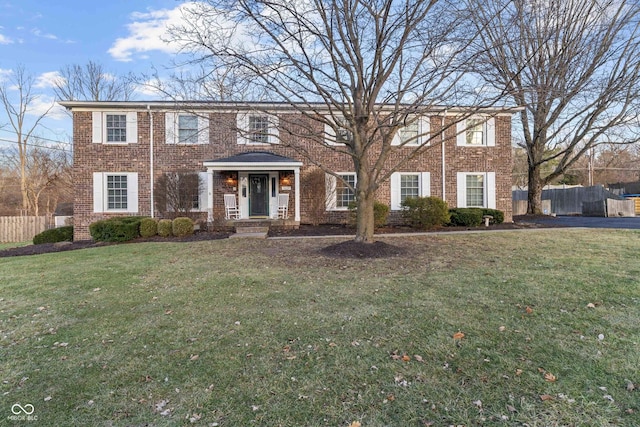 colonial home with a front lawn