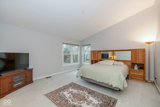 bedroom featuring vaulted ceiling and light carpet