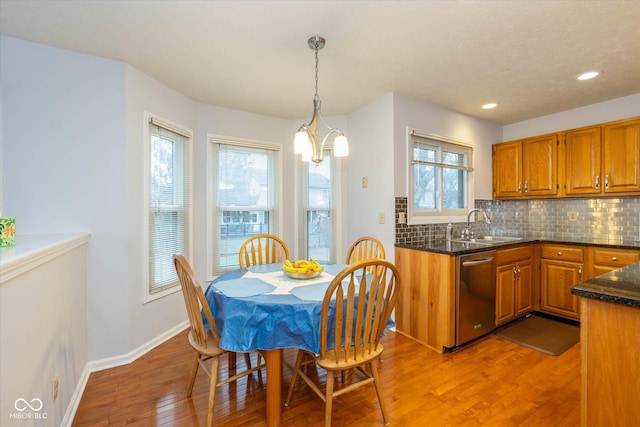 dining space featuring sink and light wood-type flooring