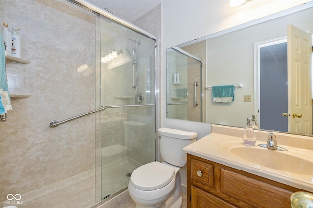 bathroom featuring vanity, an enclosed shower, and toilet