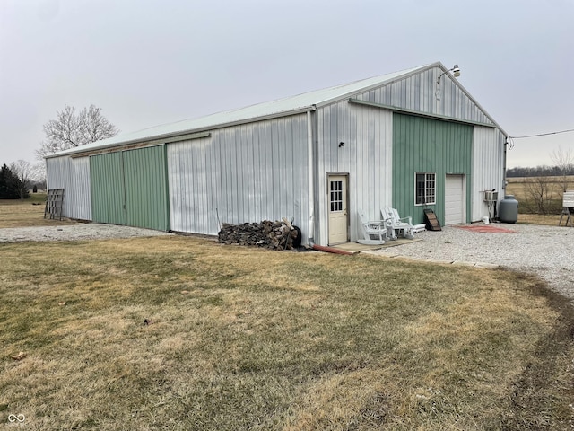 view of outbuilding featuring a garage and a yard