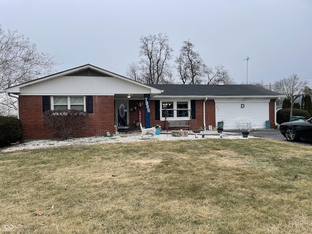 single story home featuring a garage, brick siding, and a front yard