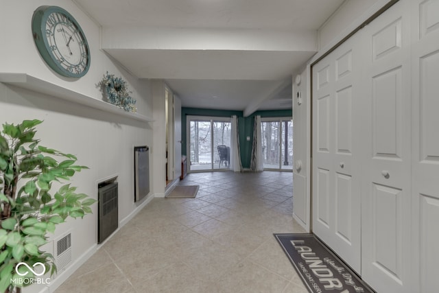 interior space featuring heating unit and light tile patterned floors