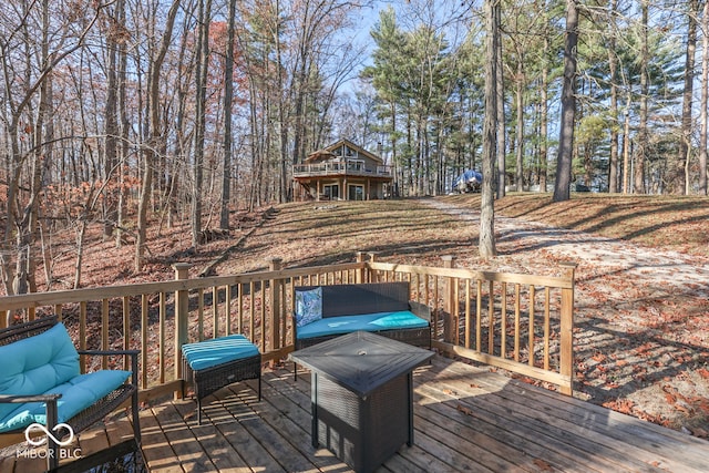 wooden terrace with an outdoor living space