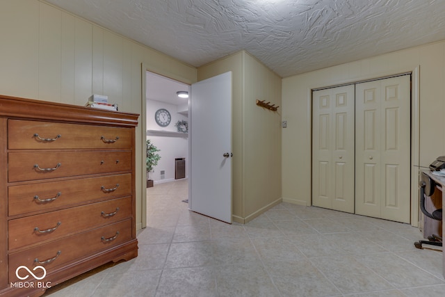 interior space featuring a textured ceiling and a closet