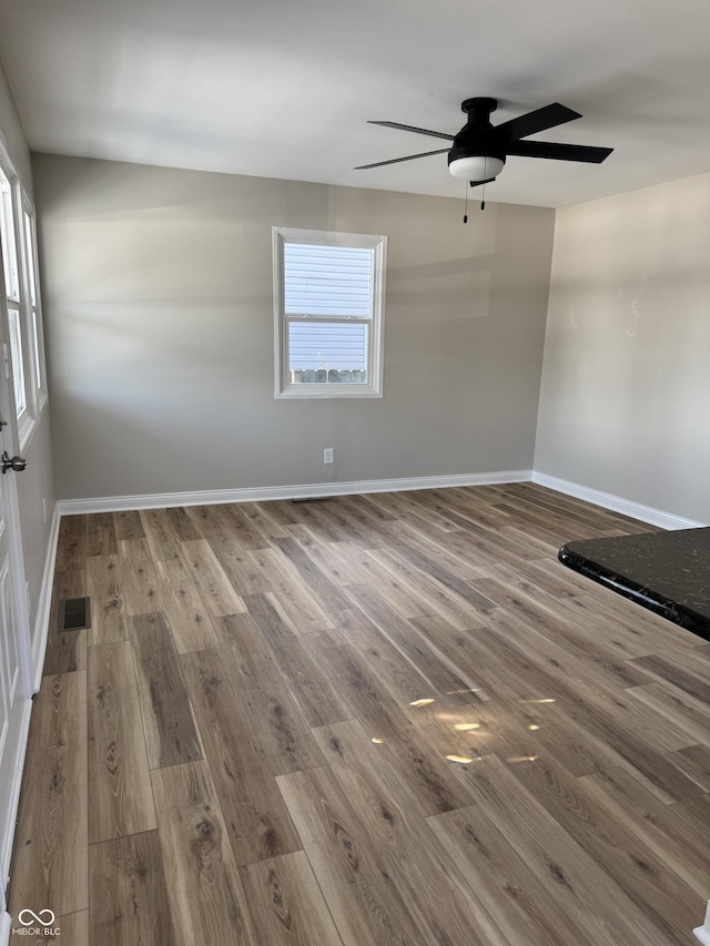 spare room with wood-type flooring and ceiling fan