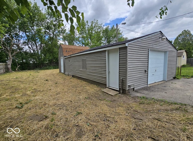 2414 Walker Ave, Indianapolis, IN 46203 - detached garage featuring asphalt driveway