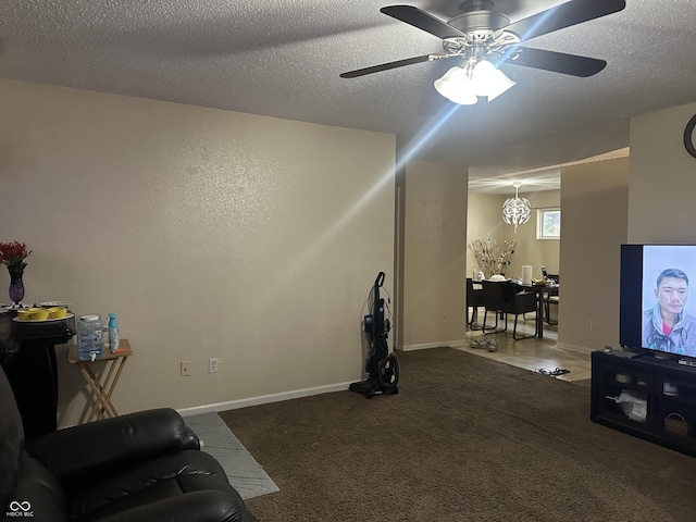 interior space with ceiling fan, a textured ceiling, and carpet