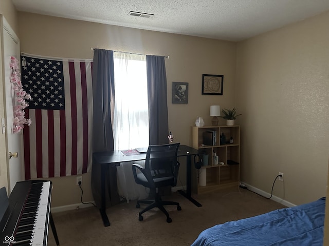 bedroom featuring carpet floors and a textured ceiling