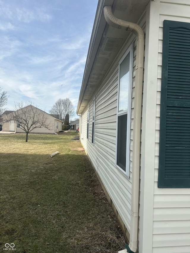 view of side of home featuring a yard