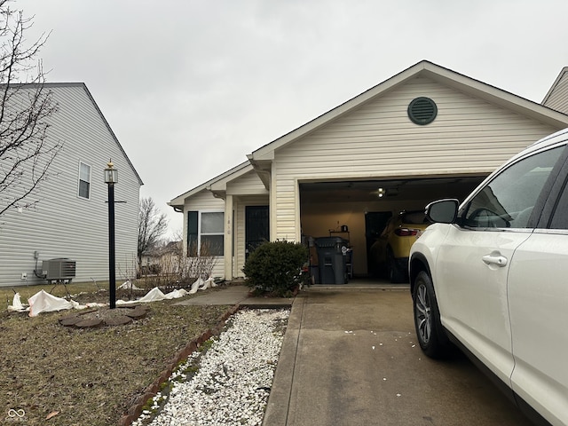 view of front of home featuring a garage and central AC unit