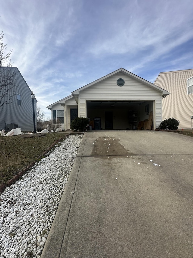 ranch-style house featuring central AC unit and a garage