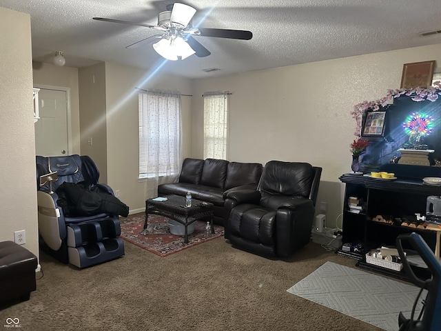 living room with ceiling fan, carpet, and a textured ceiling