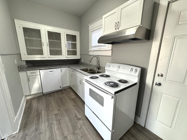 kitchen with white appliances, glass insert cabinets, dark wood-type flooring, and a sink