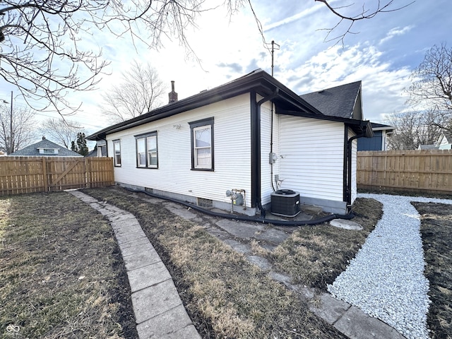 view of property exterior with fence and a chimney