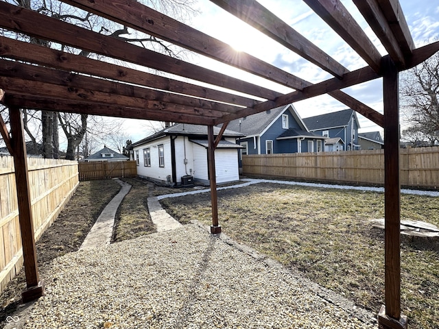 view of yard with a fenced backyard, a pergola, and an outdoor structure