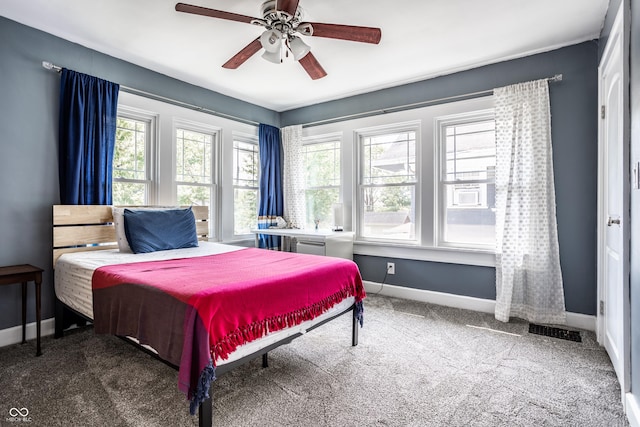 bedroom featuring ceiling fan and dark carpet