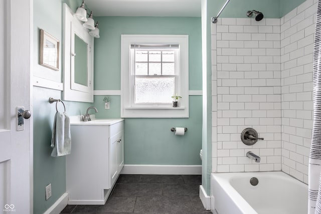 bathroom featuring tiled shower / bath, vanity, and tile patterned floors