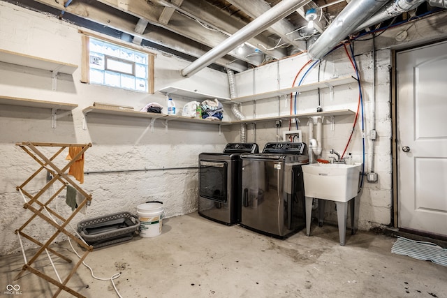 clothes washing area with washing machine and clothes dryer