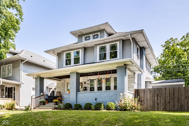 view of front of house featuring a front yard and covered porch