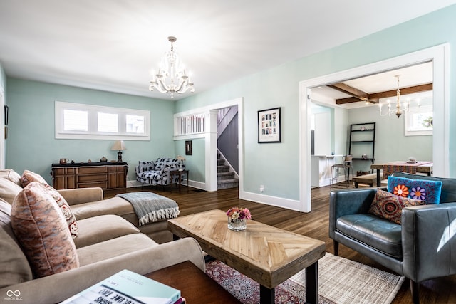 living room featuring an inviting chandelier, dark hardwood / wood-style floors, and beam ceiling