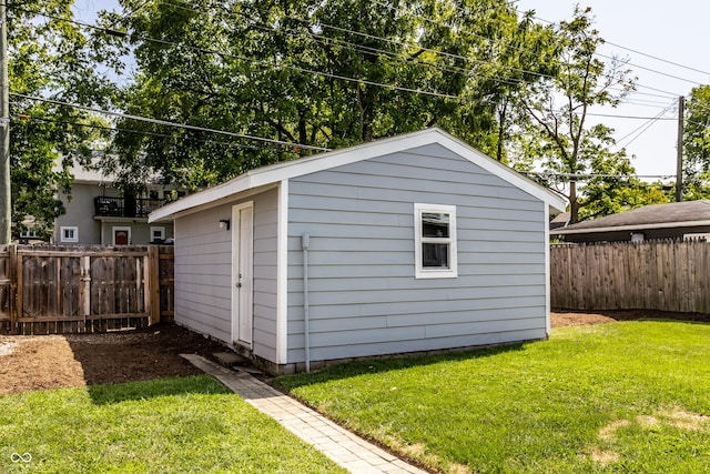 view of outbuilding featuring a yard